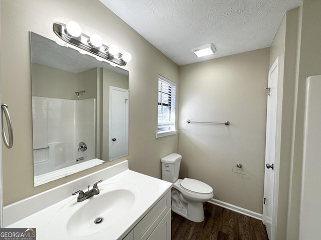 bathroom with vanity, toilet, a textured ceiling, and hardwood / wood-style flooring