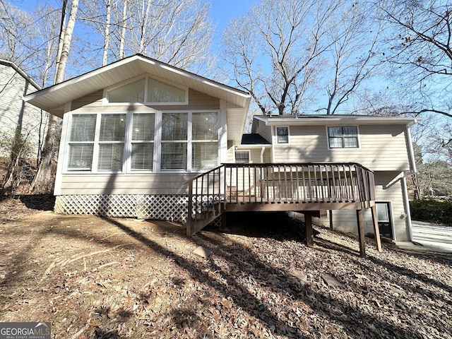 back of house with a deck and a sunroom