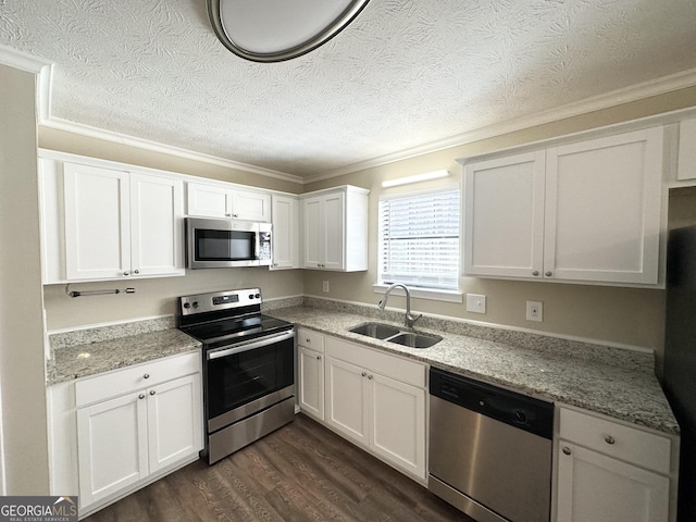 kitchen with sink, dark hardwood / wood-style flooring, white cabinetry, and stainless steel appliances