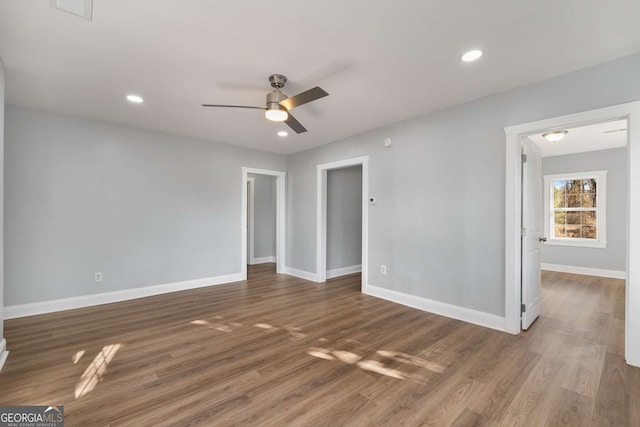 unfurnished room featuring ceiling fan and dark hardwood / wood-style floors