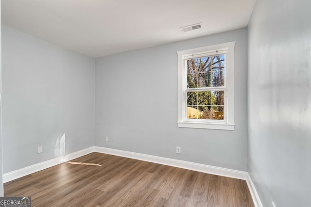 spare room featuring hardwood / wood-style floors