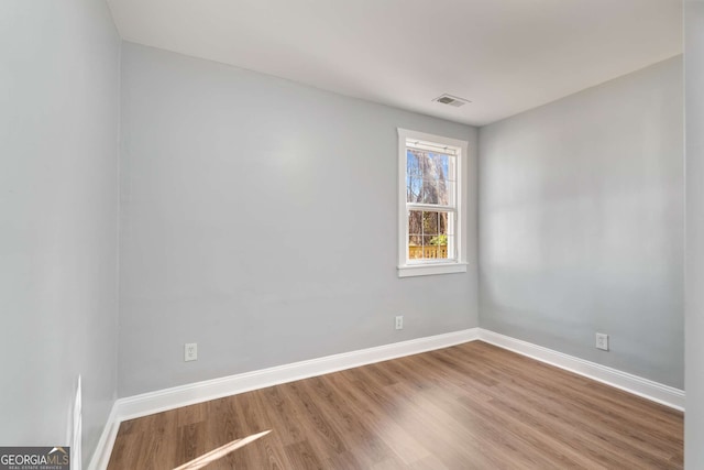 empty room featuring hardwood / wood-style flooring