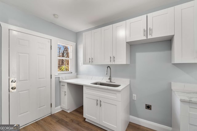 clothes washing area featuring cabinets, electric dryer hookup, sink, and dark hardwood / wood-style flooring