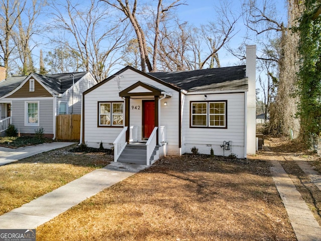 view of front of house featuring a front yard and central air condition unit