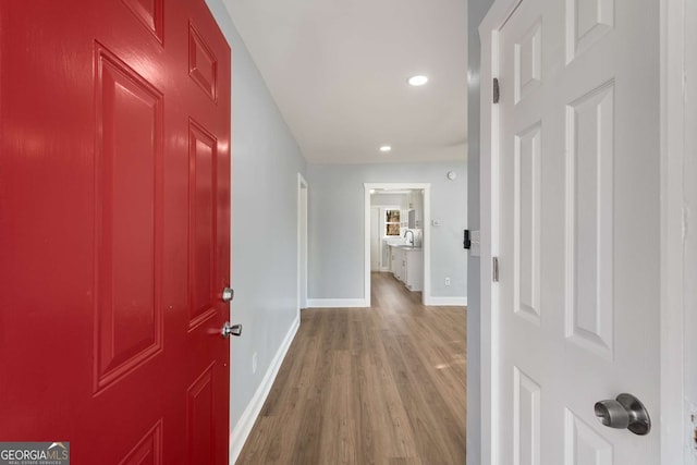 hallway with hardwood / wood-style flooring