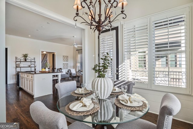 dining area with crown molding, ceiling fan with notable chandelier, beverage cooler, and dark hardwood / wood-style flooring