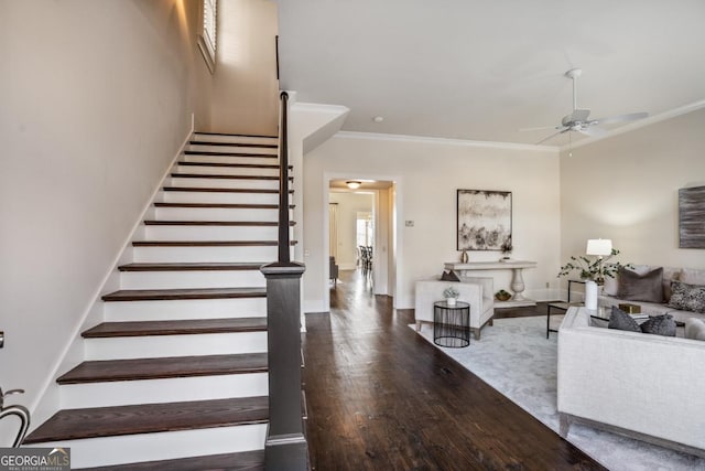 staircase featuring hardwood / wood-style flooring, crown molding, and ceiling fan