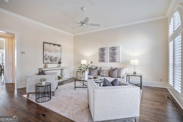 living room featuring ornamental molding, dark hardwood / wood-style floors, and plenty of natural light