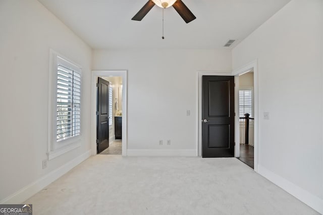 unfurnished bedroom with light carpet and ceiling fan