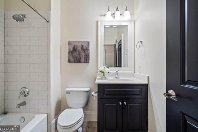 full bathroom featuring vanity, tile patterned flooring, toilet, and tiled shower / bath