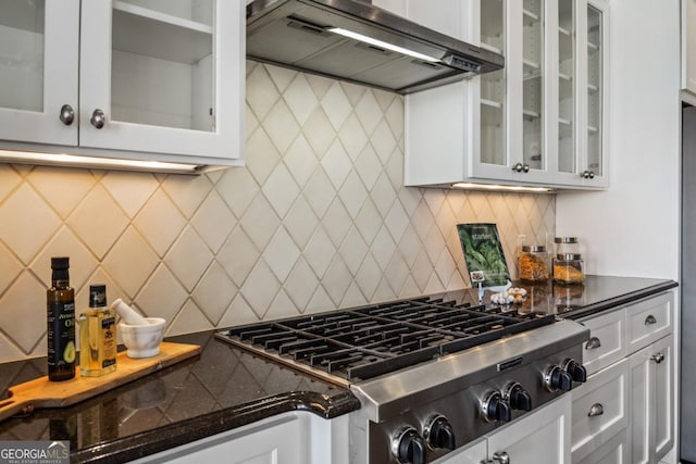 kitchen with white cabinetry, wall chimney range hood, tasteful backsplash, and stainless steel gas stovetop