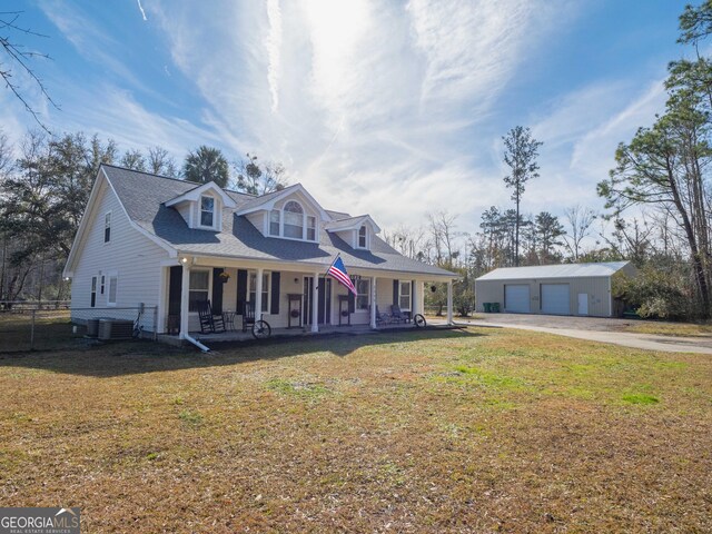 cape cod home with a porch, a garage, an outdoor structure, central AC unit, and a front yard