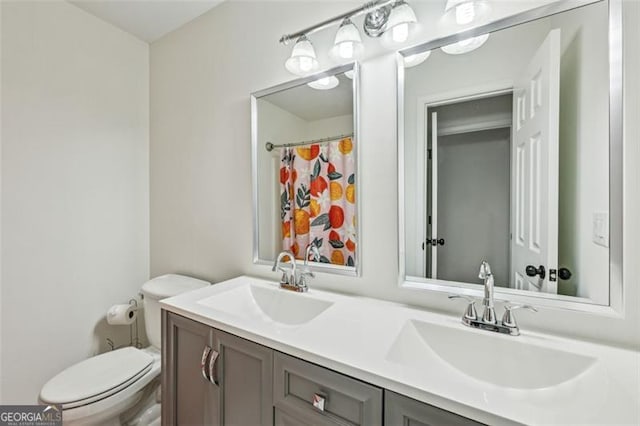 bathroom featuring vanity, toilet, and a shower with curtain