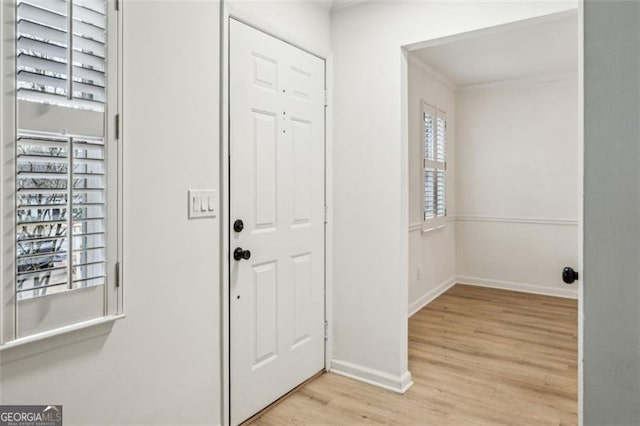 entrance foyer with light wood-type flooring and a healthy amount of sunlight