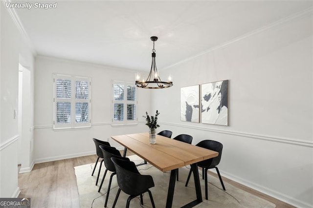 dining room featuring a chandelier, light hardwood / wood-style flooring, and ornamental molding