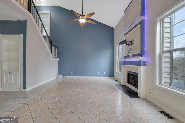 unfurnished living room featuring high vaulted ceiling, light tile patterned floors, built in features, and ceiling fan