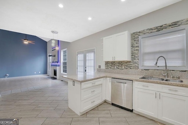 kitchen featuring pendant lighting, dishwasher, sink, white cabinets, and kitchen peninsula