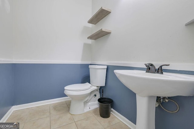 bathroom with tile patterned floors and toilet