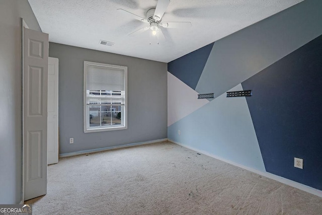 unfurnished room with light carpet, a textured ceiling, and ceiling fan