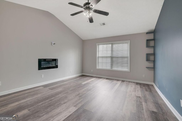 spare room featuring ceiling fan, lofted ceiling, and hardwood / wood-style floors