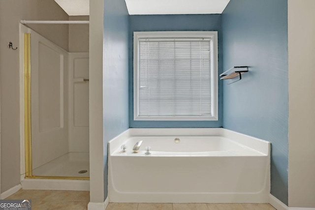 bathroom with tile patterned flooring and separate shower and tub