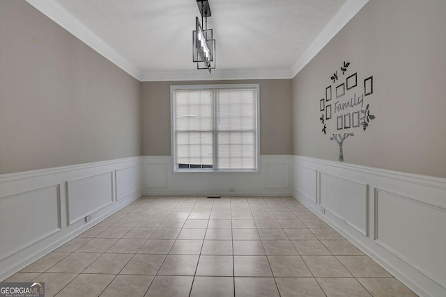 unfurnished dining area with light tile patterned floors and ornamental molding