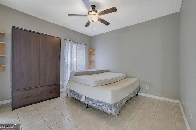 bedroom featuring light tile patterned floors and ceiling fan