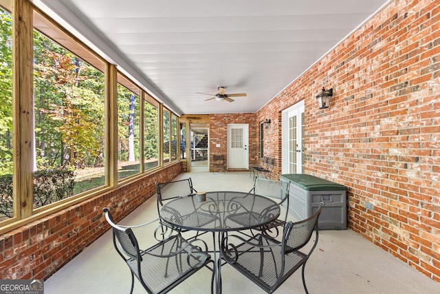 sunroom / solarium featuring ceiling fan