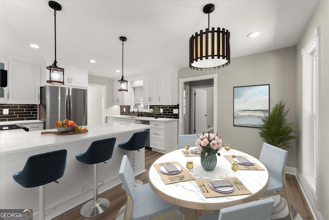 dining space featuring dark hardwood / wood-style flooring and sink