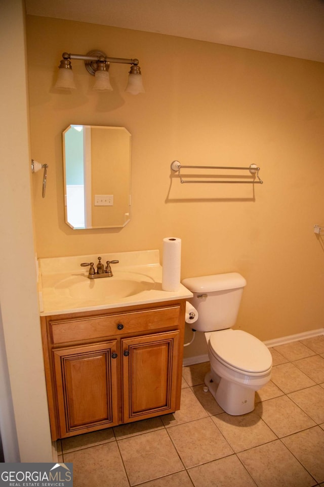 bathroom with tile patterned floors, vanity, and toilet