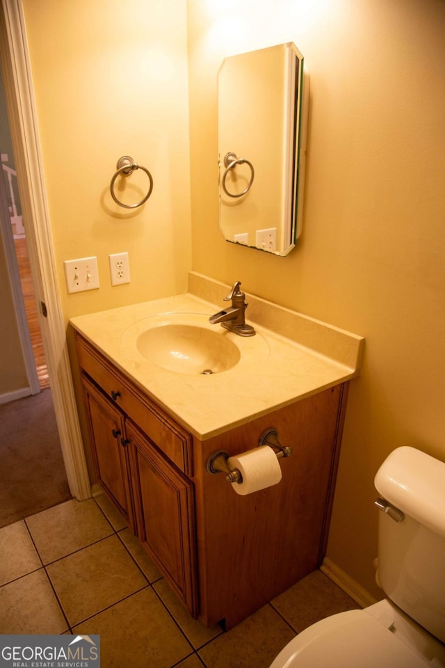 bathroom with vanity, toilet, and tile patterned flooring