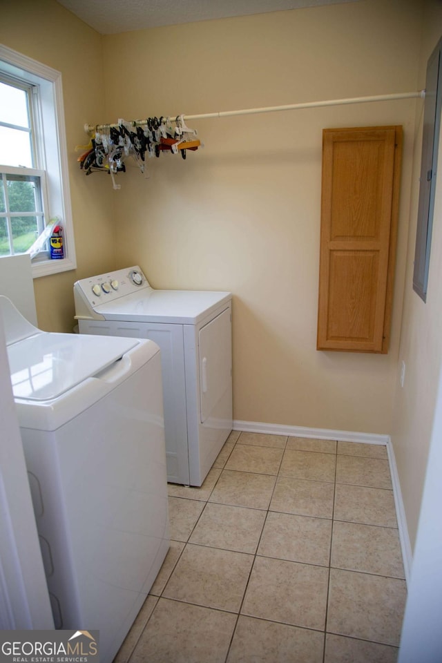 clothes washing area featuring independent washer and dryer and light tile patterned floors