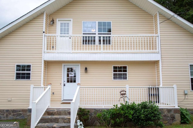 back of house featuring a balcony