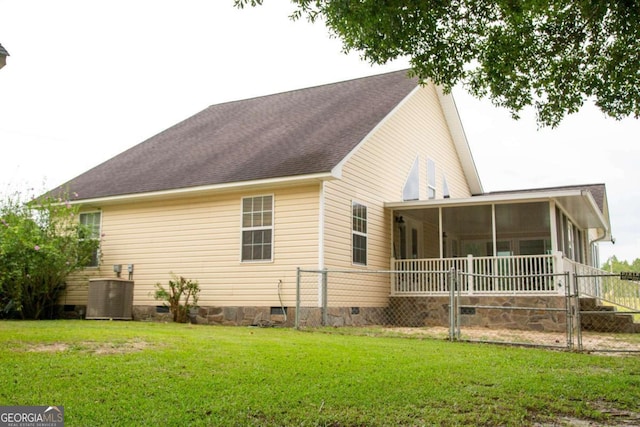 view of home's exterior featuring central air condition unit, a sunroom, and a lawn