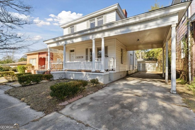 view of front of home featuring a porch and a carport