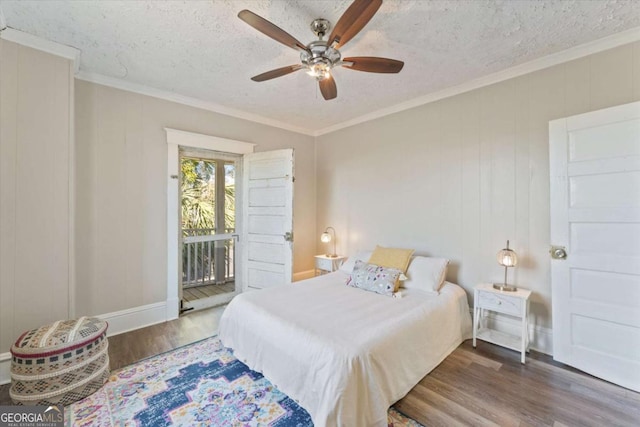 bedroom with ceiling fan, hardwood / wood-style floors, crown molding, and a textured ceiling