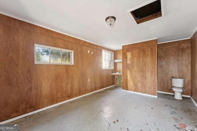 interior space featuring wood walls and concrete flooring