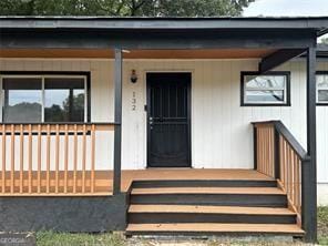 view of exterior entry featuring a porch