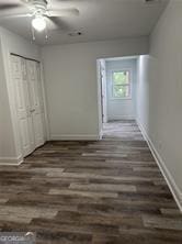 corridor with dark hardwood / wood-style floors