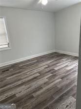 unfurnished room with dark hardwood / wood-style floors