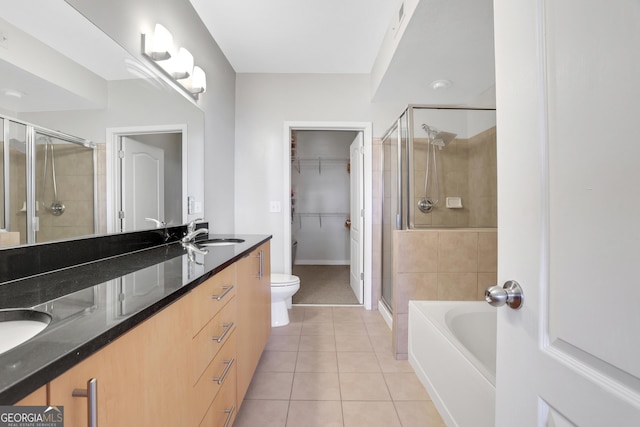 full bathroom featuring vanity, toilet, tile patterned floors, and separate shower and tub