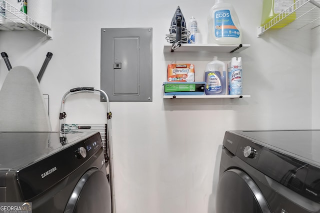 clothes washing area featuring electric panel and washer and dryer