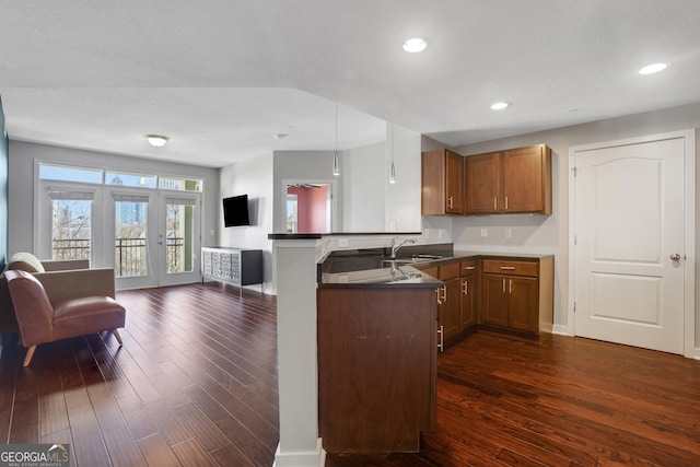 kitchen with sink, french doors, kitchen peninsula, and dark hardwood / wood-style flooring