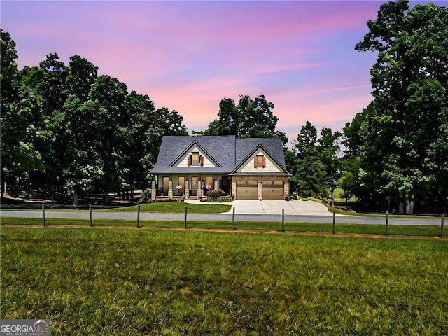 view of front facade with a garage and a lawn