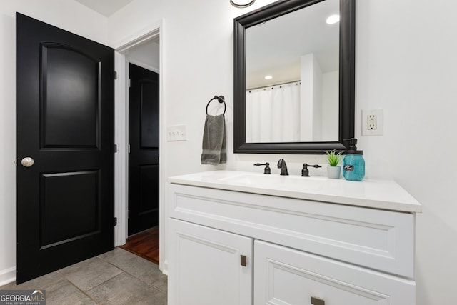 full bath featuring vanity and tile patterned floors