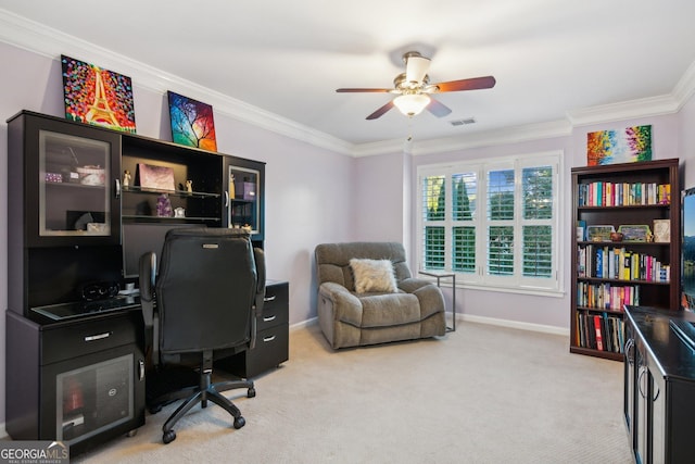 carpeted home office with ceiling fan and crown molding