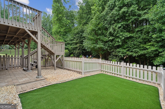 view of yard featuring a patio area and a deck