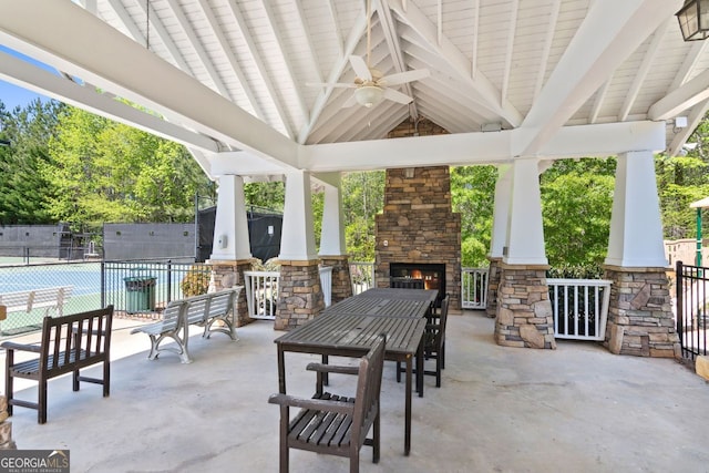 view of patio / terrace featuring a gazebo, an outdoor stone fireplace, and ceiling fan