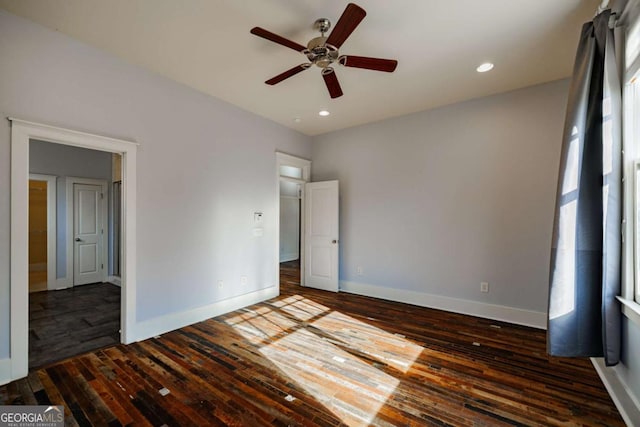 unfurnished bedroom with ceiling fan and dark hardwood / wood-style floors