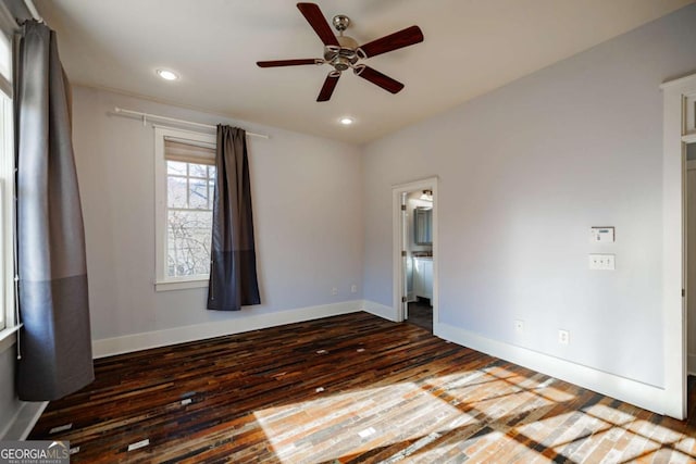 empty room featuring ceiling fan and dark wood-type flooring